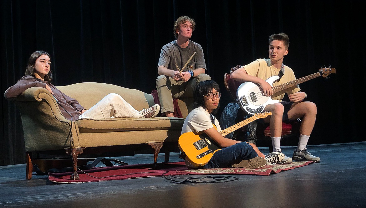 Very Real poses on stage. (Left to right: Sarah Kingsford, Jensen Hallock-Wishner, Andrew Myint, and Ethan Creadon)