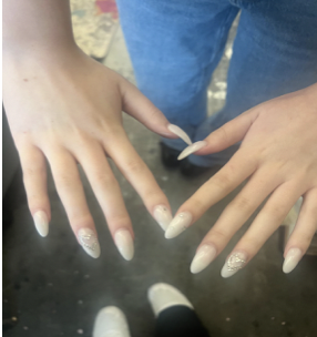 Freshman Hayden Bean’s nails, painted with a white base and decorated with silver gems.