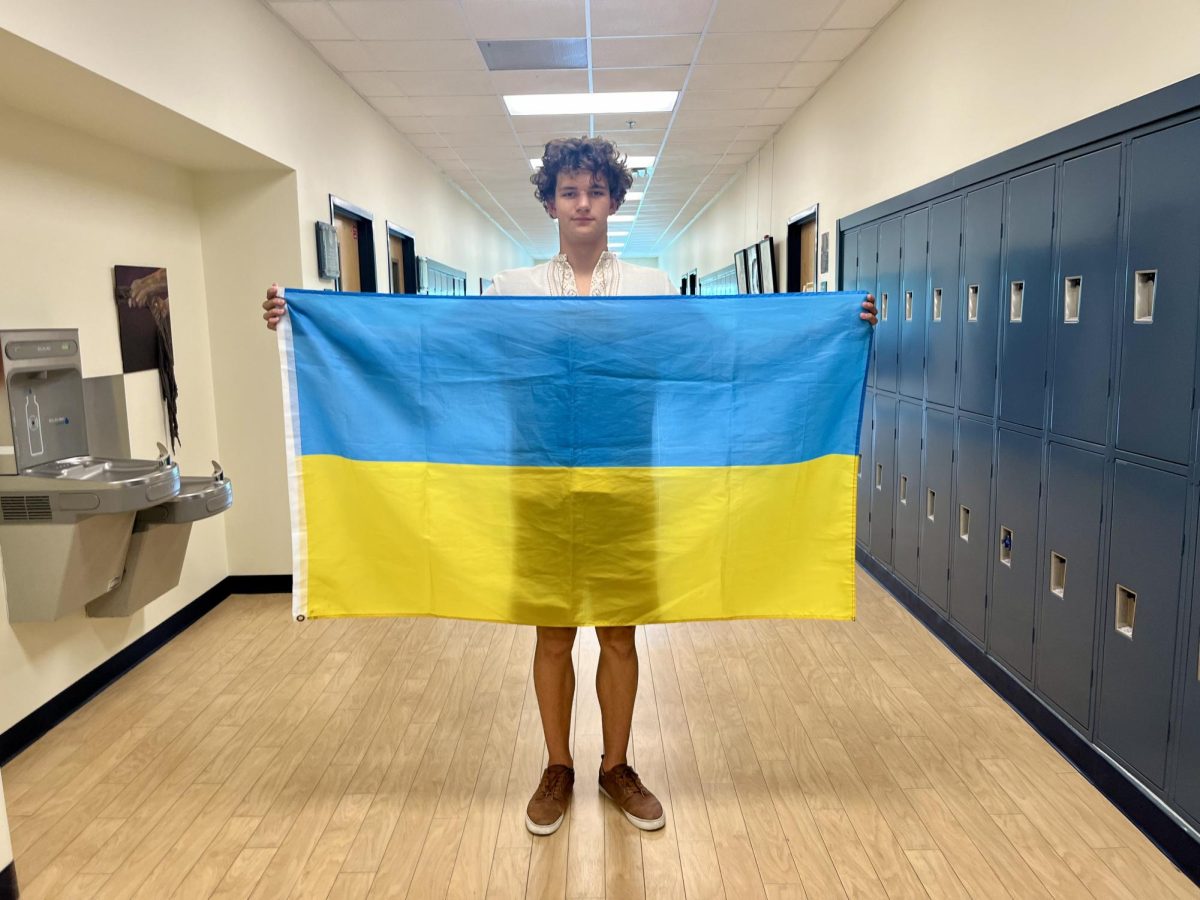Ivan+Spodin+poses+with+a+Ukrainian+flag+while+wearing+a+traditional+Ukrainian+shirt.+Spodin+and+his+family+moved+to+Florida+from+Ukraine+on+December+16th%2C+2021.