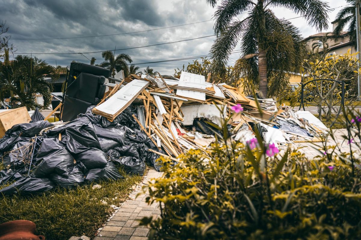 Destroyed doors, walls, and furniture sit in a yard in Snell Isle. 