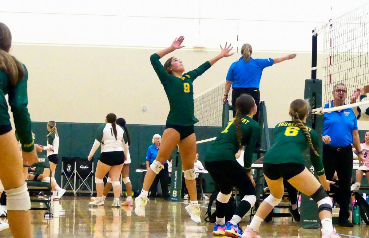 Junior Olivia Nicklaus (far left) prepares to spike the ball while eighth grader Hayden Z.

(middle) and sophomore Ava Gurievsky (far right) cover for her during the Charger Invitational Tournament on October 5, 2024 in the Crisp Gym. 