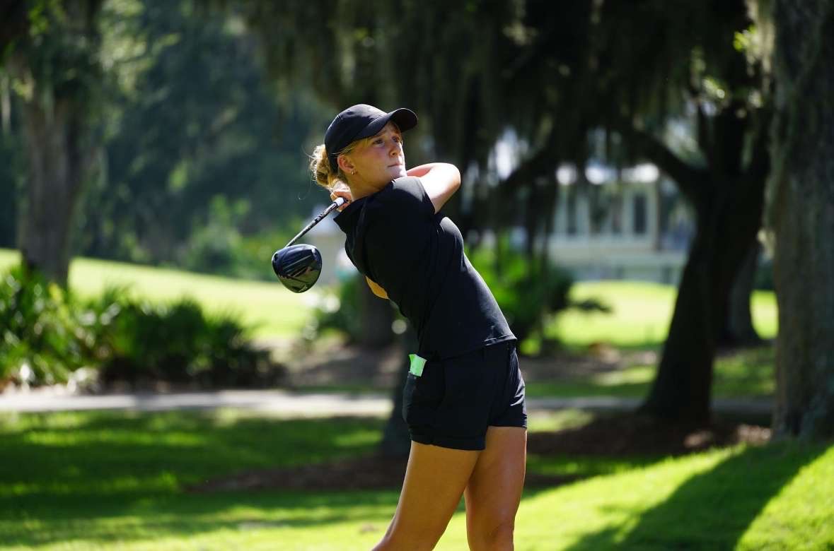 Junior Sophia Dyer perfects her swing during a practice session on the course.