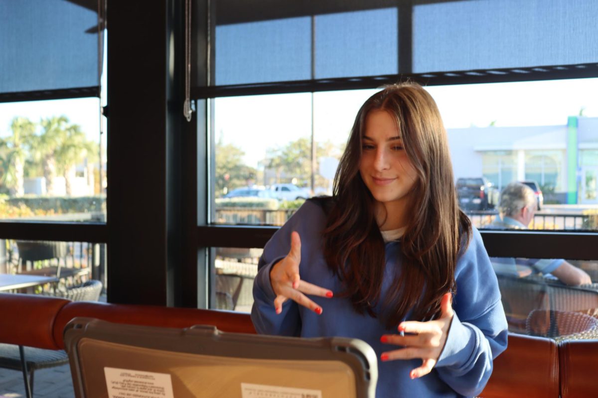 Junior Georgia Kurland pictured practicing for her American Sign Language (ASL) class at a local coffee shop.