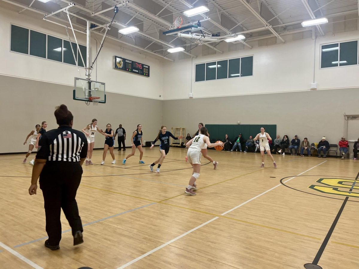 Senior Annabelle Ferguson dribbles the ball during the second half of the varsity girls basketball game on January 21st, which was moved into the Rec Gym due to a water leak. The Chargers won the game 34-31. 
