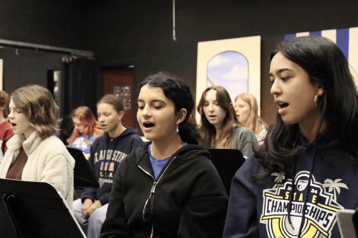 Members of The Addams Family cast rehearse songs in the black box theater. 