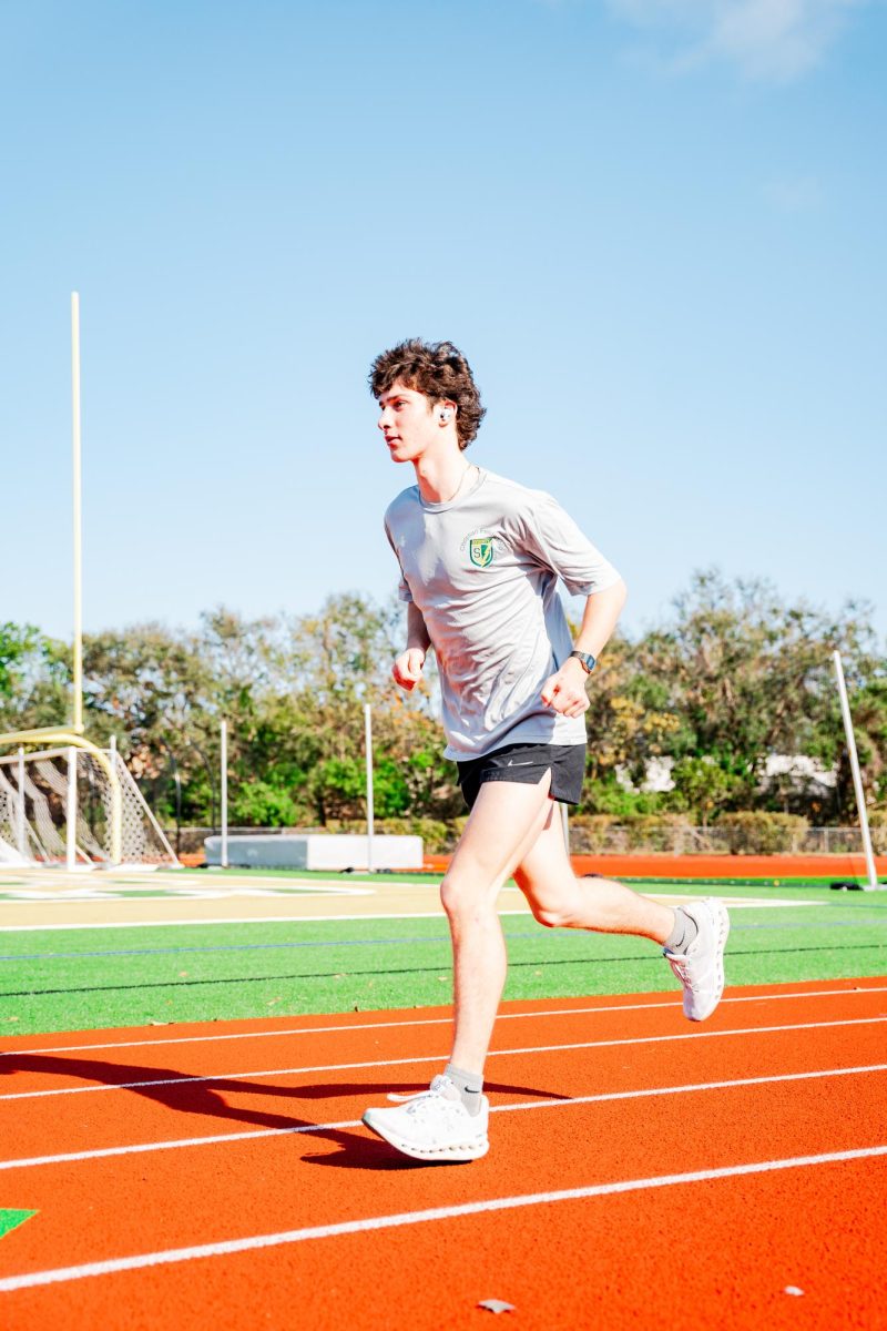 Asher Walton, runner on the track and cross country team, runs as he listens to his music.