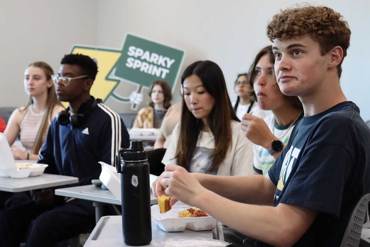 Students listen attentively as junior Anastasia Davis teaches about Russian culture during the first Harmony Across Borders meeting. 
