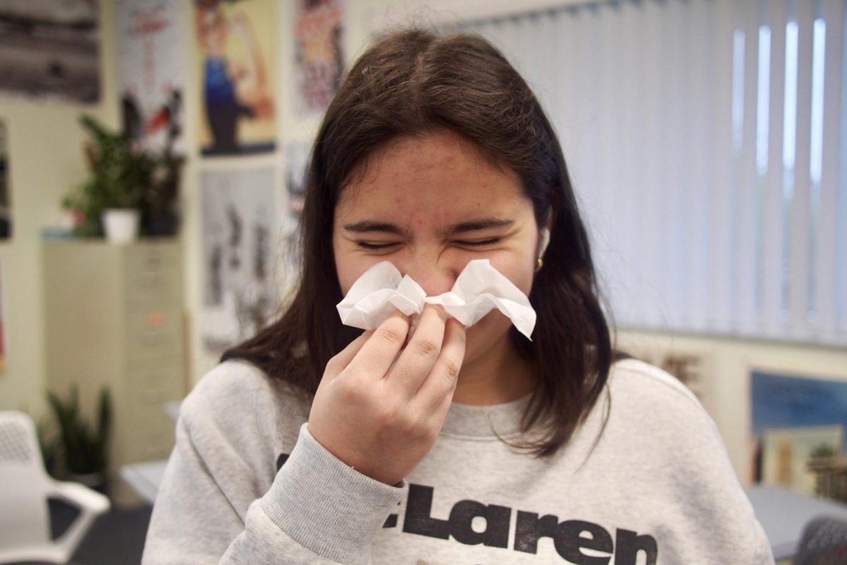 A student blows their nose into a tissue as illnesses spread through classrooms. This winter, 55.8 percent of sick respondents reported having a common cold, with sore throats and coughs being the most frequently mentioned symptoms.