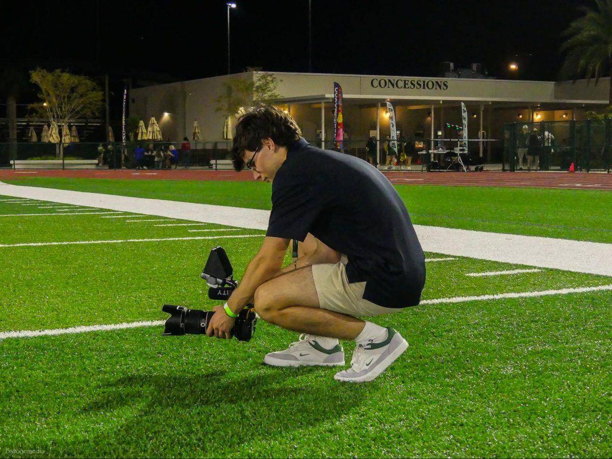 Senior Cole Goldenberg takes photos at the varsity football team’s state championship game in The Villages on November 14th, 2024