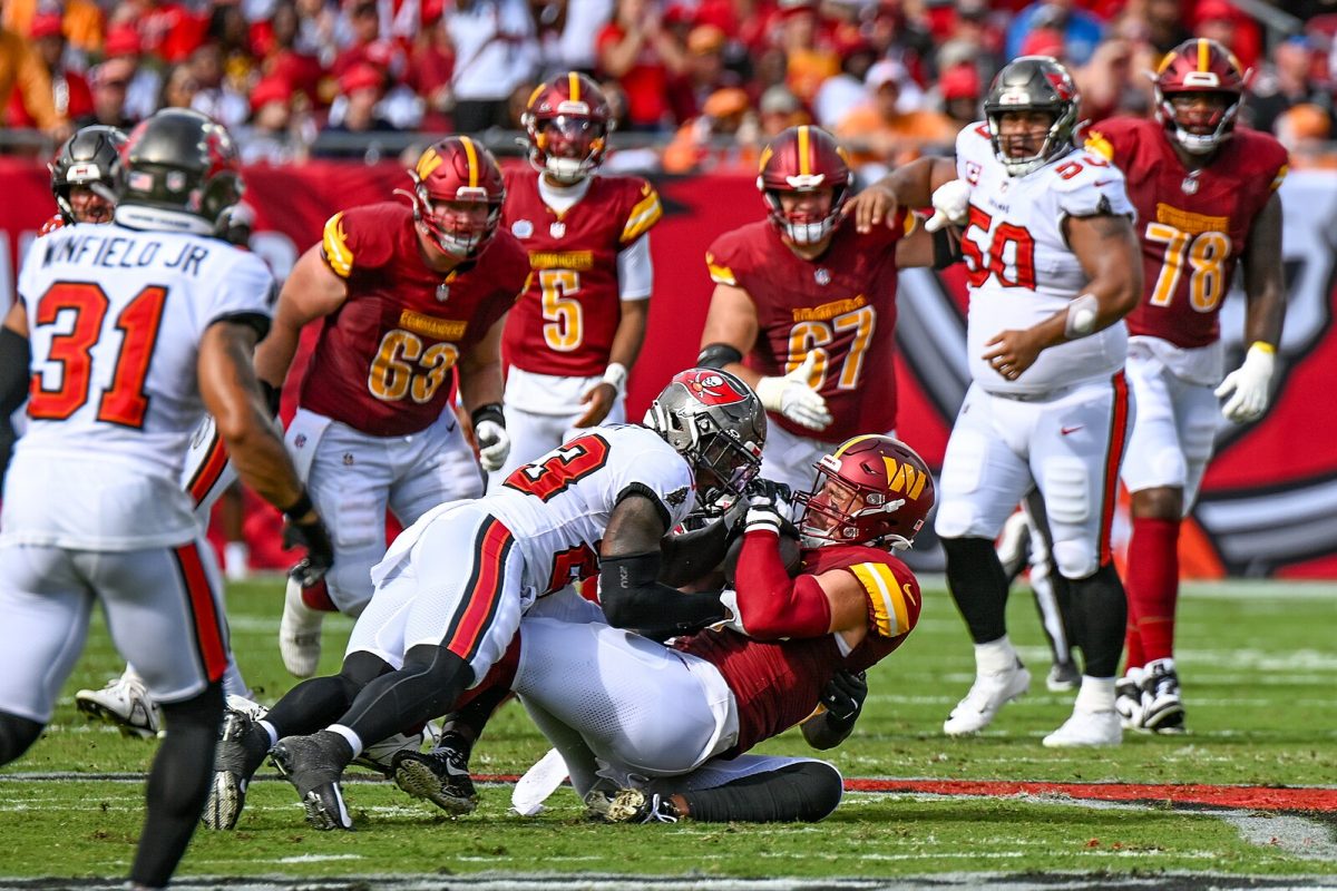 A Bucs defensive player tackles a Washington Commander during their game to open the season on September 8th, 2024. The Bucs won this game 37-20. Photo by Joe Glorioso of All-Pro Reels. CC by S-A 2.0 License.

