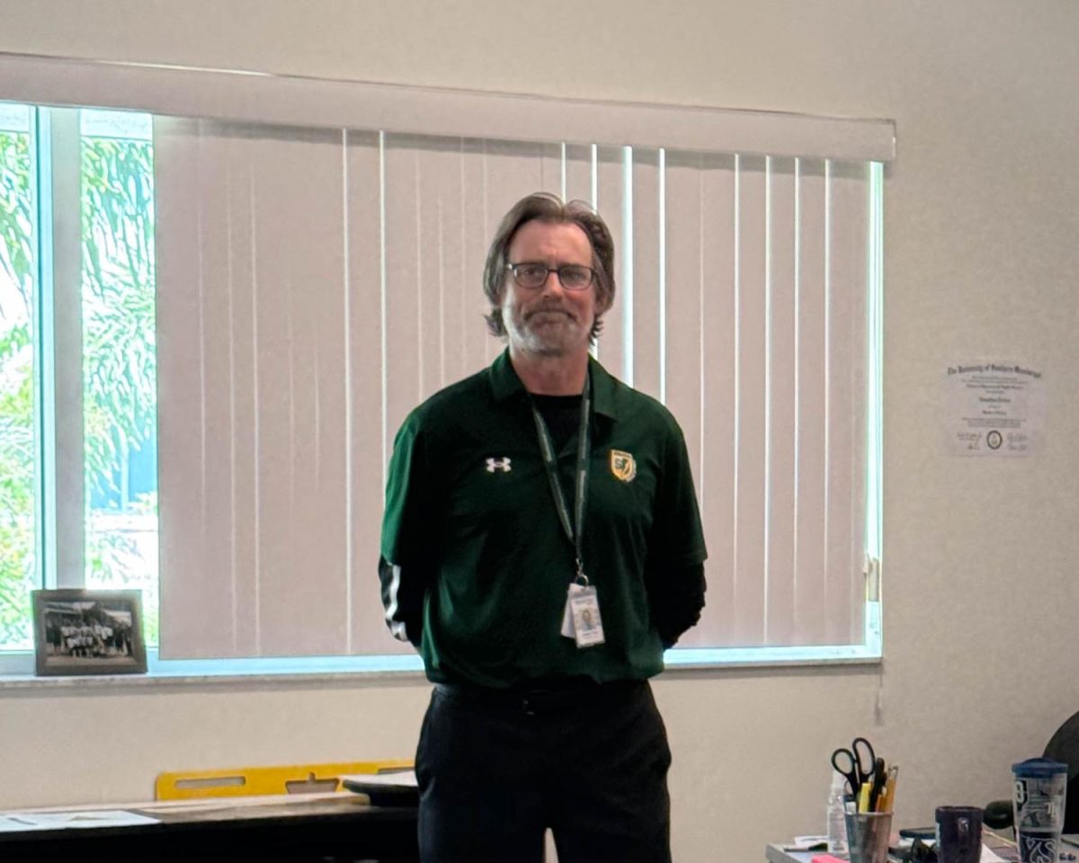 US Health Teacher and Coach Jonathan Tallon standing in his new classroom. Although holding a new position, he is not new to the Shorecrest community as he was a coach for the Middle School girls basketball team in years prior.