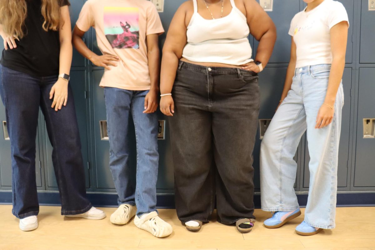 Students (left to right: junior Margo Armstrong, junior Cassan Johnson, senior Mila Bianco and freshman Hayden Zielinski) pose in their jeans. After the Shorecrest dress code prohibited leggings and sweatpants, jeans have increased in popularity.