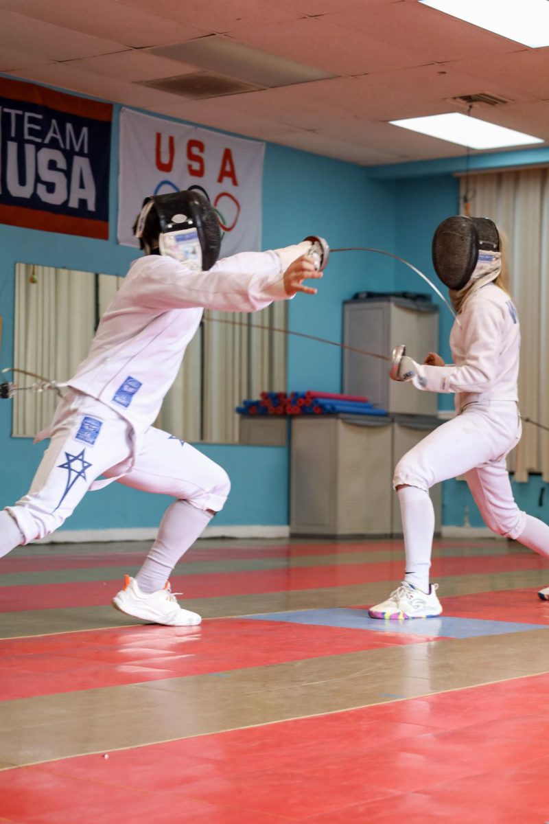 Junior Michael Mizrahi fences at Tampa Fencing Academy. He practices every day alongside his girlfriend Anna Walter. Photo by Sloane Williams.