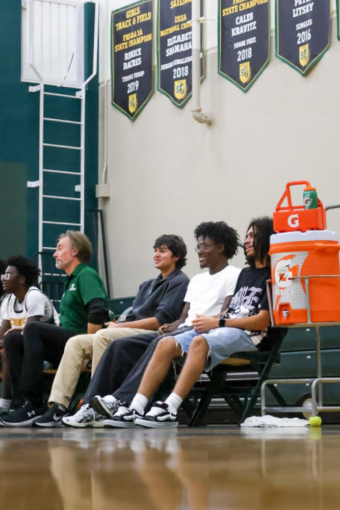 Varsity boys basketball players sophomore Sonny Dua, senior Damarion Feaster and senior Decedric Dillard sit on the bench during the team's game on December 2 against Bayshore Christian. The three were suspended due to leaving the bench in an altercation during their previous game against St. Pete Catholic.