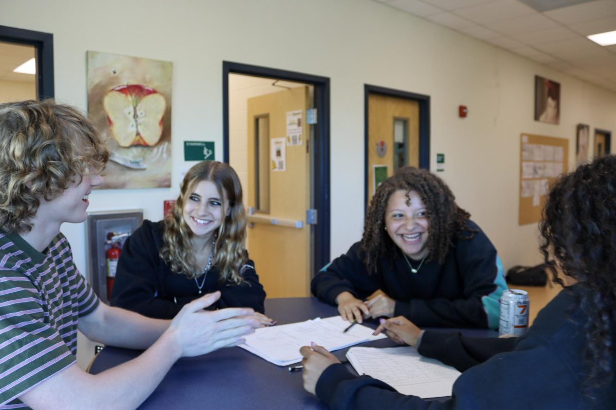 Sophomores (left to right: Bear Brummett, Zoi Ricalde, Bianca Felipe, and Sara Ferris) laugh at a table in Landy Hall. Tenth grade students learned to create strong bonds through Community Tampa Bay. 