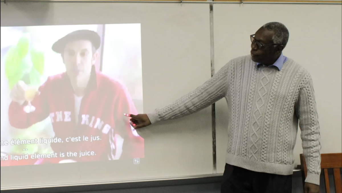 Upper School World Languages Teacher Sidy Ndiaye explains a French video to his students. In retirement, Sidy plans to travel, spend time with family and do community service