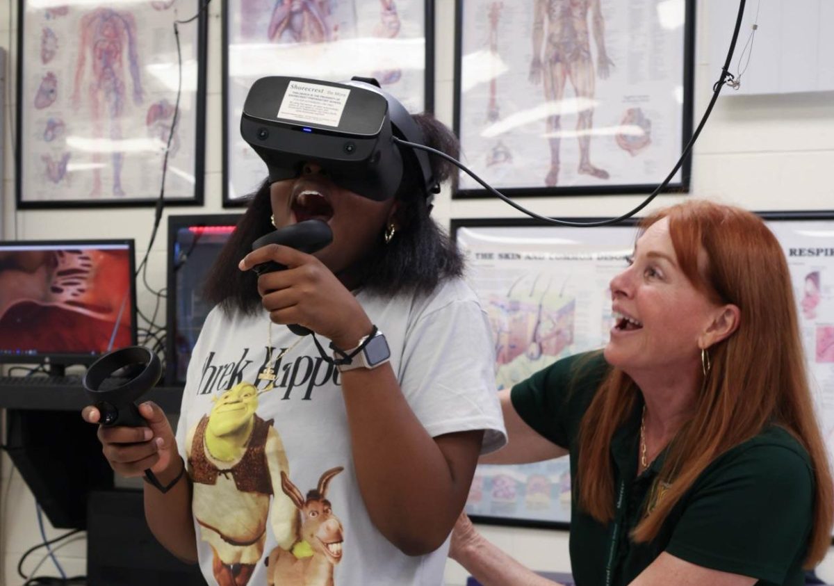 US Science Teacher Lisa Peck instructs junior Donyae Hazley through virtual reality. During this lesson, students were exploring what the interior of organs, such as the heart, look like in 3D. 