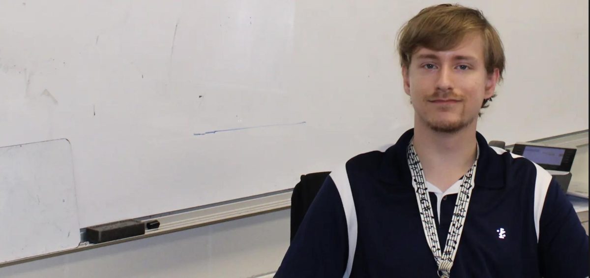 Upper School Physics/Math Teacher Alex Roush poses for a headshot at his desk. Roush hopes to advance his animation skills for his channel in the future. 