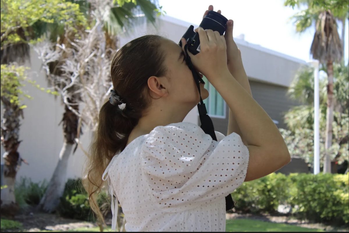 Junior Margo Armstrong takes a picture during her AP Photography class. Armstrong has been pursuing photography since middle school.