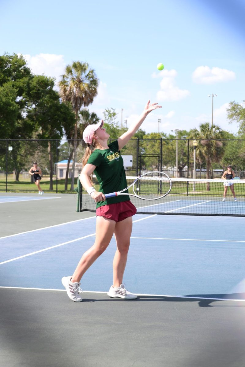 Junior Isabella Jank serves during a tennis match. The girls tennis team made it to the state championship this year.
