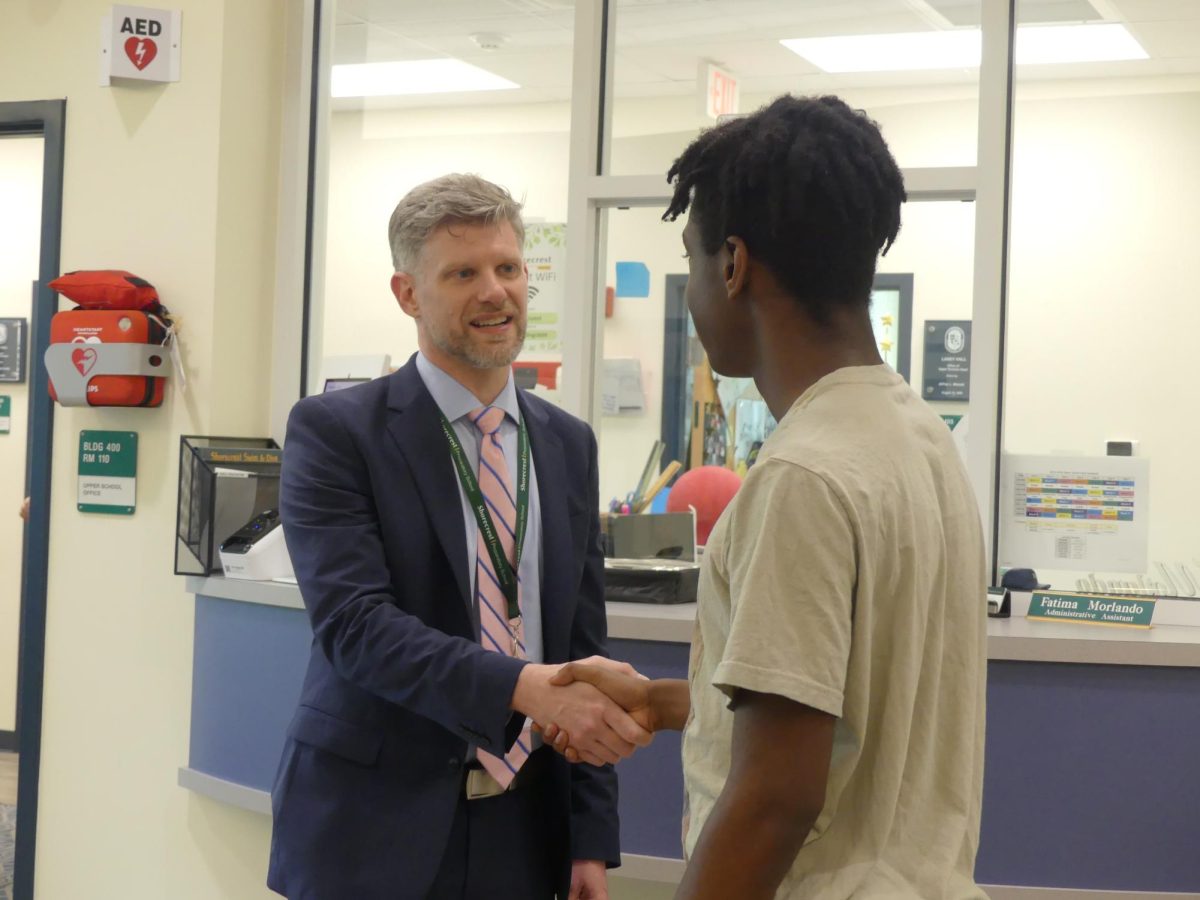 Incoming Head of Upper School Brendan Hoyle introduces himself to senior Caleb Williams. Hoyle was on campus on April 17 to attend meetings and watch the Upper School performance of "Oklahoma!"