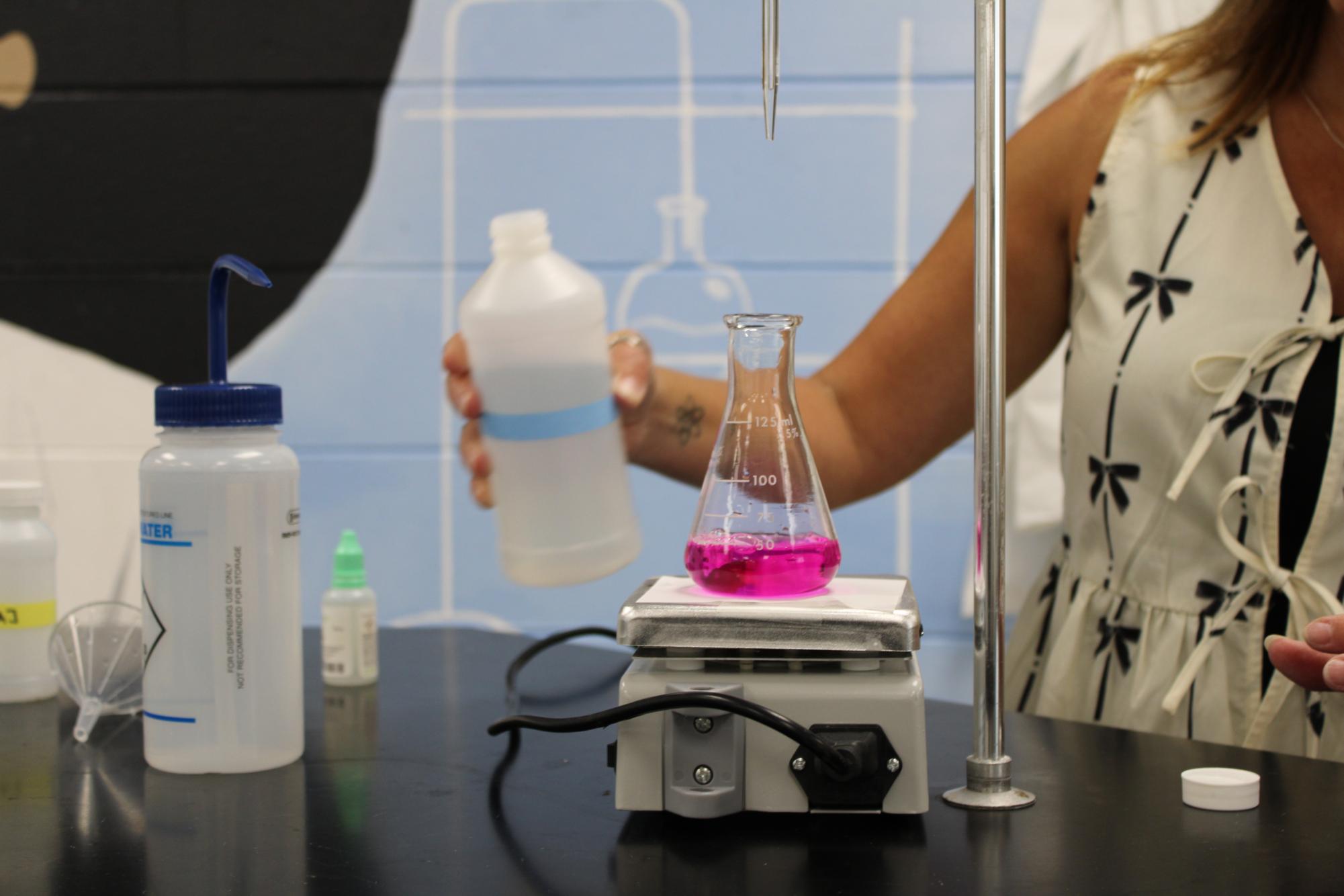 Science teacher Carlie Saval performs a titration for one of her chemistry classes. Dr. Carlie will begin teaching a new class next year, AP Environmental Science, where students will learn about the environment and human impact on it.